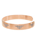 Gold cuff bracelet with engraved tribal swirl design – fashion accessory  
